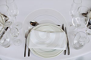 Classic white decor of a festive dinner table in a restaurant