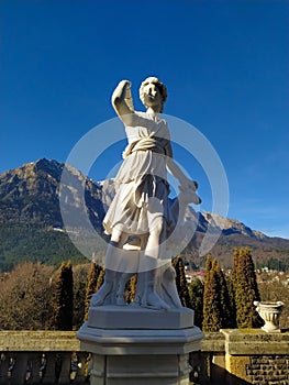 Classic white marble statuette Diana statue  on blue sky background. Scilpture of huntress