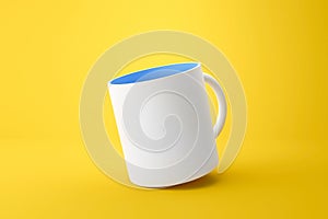 Classic white mug and blue inside on vivid yellow summer background with blank template mockup style. Empty cup or drink mug. 3D