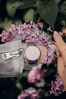 Classic white watch on woman hand. Close-up photo