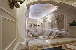 Classic wide corridor with marble floor and carpet