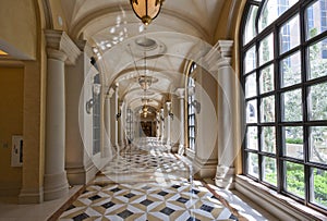 Classic wide corridor with marble floor and carpet