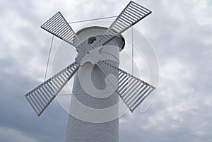 classic windmill in front of clouds