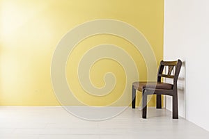 Classic wooden chair on yellow wall