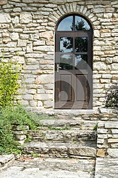 Classic wooden door on stonewall, Balchik