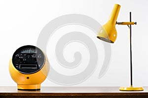 Classic yellow radio receiver with vintage table lamp