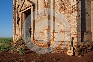Classical acoustic guitar in ruins of abandoned church