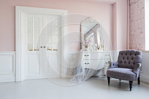 Classical armchair and mirror table at living room interior