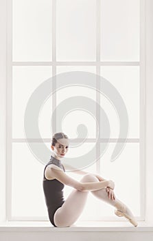 Classical Ballet dancer portrait at window background