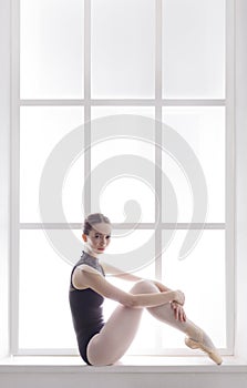 Classical Ballet dancer portrait at window background