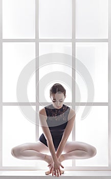 Classical Ballet dancer portrait at window background