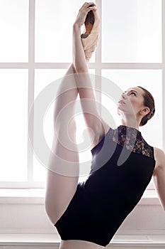 Classical Ballet dancer in split stretching, portrait