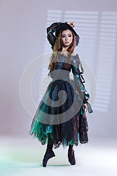 Classical Ballet Ideas. Professional Japanese Female Ballet Dancer In Flying Bat Costume Posing in Dance Pose On Pointeshoes With