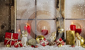 Classical christmas wooden window decoration with red candles an