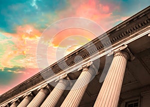 Classical columns on government building with colorful sky