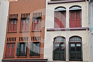 Classical dark orange and white grey front of town houses in Singapore in cloudy day