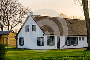 Classical dutch farmer house with a thatched roof, Architecture at the countryside of the Netherlands