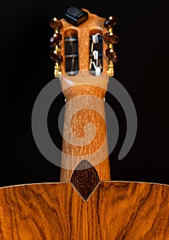 Classical guitar back detail isolated on black background