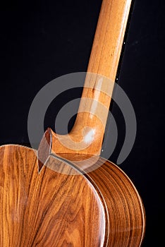 Classical guitar back detail isolated on black background