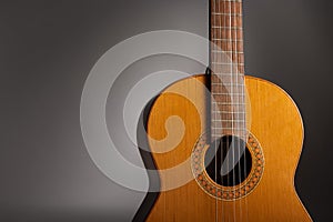 Classical guitar on a grey background with copy space