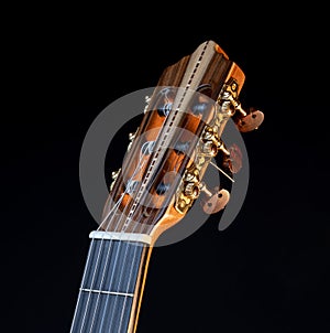 Classical guitar headstock isolated on black background