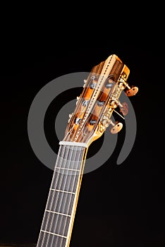 Classical guitar headstock isolated on black background