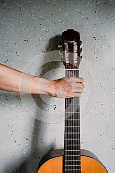 Classical guitar on patterned wall