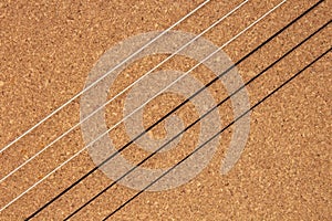 Classical guitar strings on balsa wood texture background