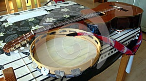 Classical guitar and tammorra on the table photo
