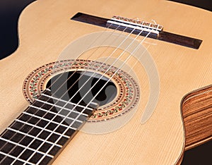 Classical guitar top isolated on black background
