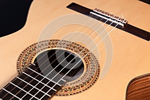 Classical guitar top isolated on black background