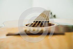 Classical guitar with vibrating strings on a white background