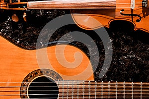 Classical guitar and violin close up view on dark background