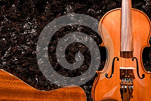 Classical guitar and violin close up view on dark background
