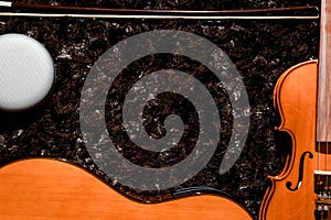 Classical guitar, violin and speaker close up view on dark copy space