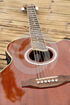 Classical guitar on wood background.