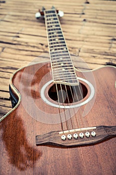 Classical guitar on wood background.