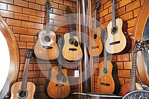 Classical guitars hanging on a wall in a music store.