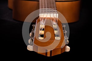 Classical headstock of traditional acoustic guitar in selective focus