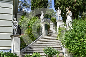 Classical inspired statues on stairs to the Achilleion palace in Gastouri, Corfu island in Greece.