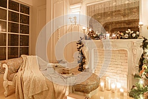 Classical interior of a white room. Christmas evening by candlelight. classic apartments with a white fireplace