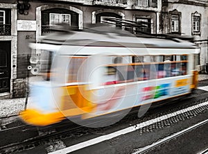 Classical Lisbon colorized touristic tram on the street, moving