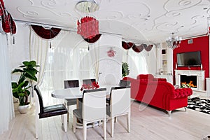 Classical living room interior in white and red colors with dinner table