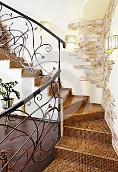 Classical mosaic stairs with ornamental handrail in hallway with