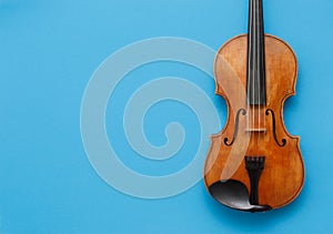 Classical music concert poster with brown color violin on blue background with copy space