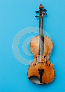 Classical music concert poster with brown color violin on blue background with copy space