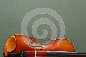 Classical music concert poster with brown color violin on dark green background with copy space