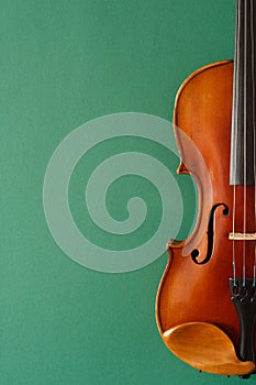 Classical music concert poster with brown color violin on dark green background with copy space