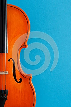 Classical music concert poster with orange color violin on blue background with copy space