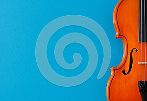 Classical music concert poster with orange color violin on blue background with copy space photo